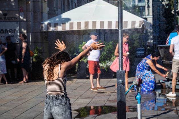 June 27, 2026, Warsaw, Mazovia, Poland: A young girl enjoys the relief of a cooling misting station. On the afternoon of the 28th of June, Varsovians cool and hydrate themselves around the city during a record-breaking heatwave. Due to the extreme heat, the authorities provided misting sprays and water tanks around the city. During the weekend, Warsaw experienced temperatures approaching 38Â°C as the unprecedented European heatwave swept across Poland, roughly 15Â°C above the late-June average. Tropical nights, nationwide heat alerts, and temperatures up to 40.5Â°C elsewhere in the country made this one of the most extreme heat events in modern Polish history. Warsaw Poland - ZUMAs197 20260627_aaa_s197_339 Copyright: xNeilxMiltonx