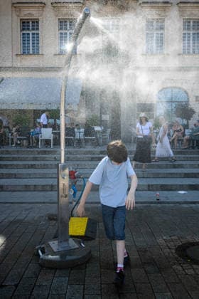 June 27, 2026, Warsaw, Mazovia, Poland: A young boy enjoys the relief of a cooling misting station. On the afternoon of the 28th of June, Varsovians cool and hydrate themselves around the city during a record-breaking heatwave. Due to the extreme heat, the authorities provided misting sprays and water tanks around the city. During the weekend, Warsaw experienced temperatures approaching 38Â°C as the unprecedented European heatwave swept across Poland, roughly 15Â°C above the late-June average. Tropical nights, nationwide heat alerts, and temperatures up to 40.5Â°C elsewhere in the country made this one of the most extreme heat events in modern Polish history. Warsaw Poland - ZUMAs197 20260627_aaa_s197_345 Copyright: xNeilxMiltonx