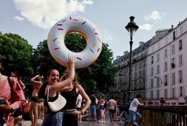 Heatwave Canal Saint Martin Paris A woman holds up a large inflatable donut near the Canal Saint-Martin in Paris, France, on June 23, 2026. As France experiences a major heatwave, people use the Canal Saint-Martin as an improvised urban beach to cool off. While the city recently opened a regulated swimming area, the extreme temperatures have led many to swim in unapproved sections of the waterway. Paris Ile de France France Copyright: xOliviaxBonnamourx