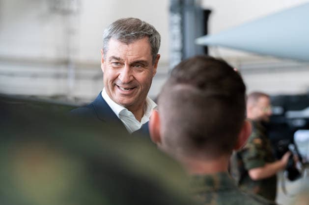 Kaufbeuren, Bavaria, Germany - June 30, 2026: Kaufbeuren Air Base, the Bundeswehr, and the German Air Force: The Future of the Arrow Weapon System for Germany (AWS-G), Air Defense, Military Base, and Pilot Project for Historic Preservation. Minister President Dr. Markus Söder (CSU) speaking with soldiers in Bundeswehr Flecktarn uniforms *** Fliegerhorst Kaufbeuren, Bundeswehr und Luftwaffe: Zukunft des Arrow Weapon System for Germany (AWS-G), Luftverteidigung, Militärstandort und Pilotvorhaben Denkmalschutz. Ministerpräsident Dr. Markus Söder (CSU) im Gespräch mit Soldaten in Flecktarn Uniform der Bundeswehr