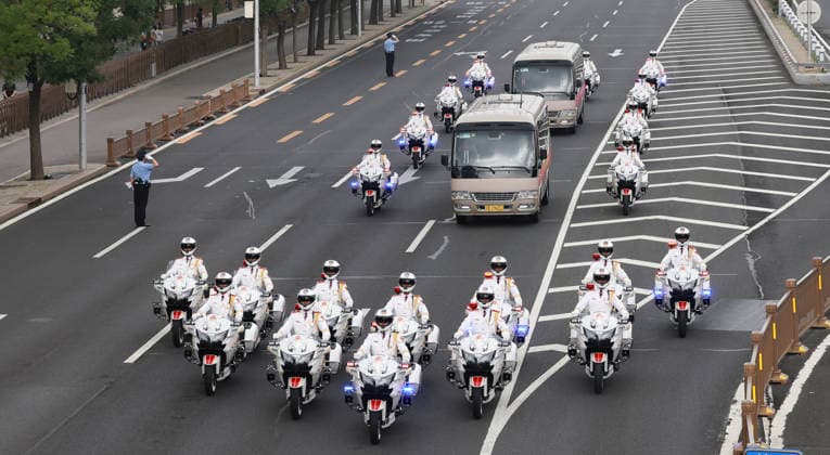 (260701) -- BEIJING, July 1, 2026 -- The motorcade carrying recipients of the July 1 Medal is accompanied by motorcycle escorts on the way to the Great Hall of the People in Beijing, capital of China, July 1, 2026. China will hold a gathering to celebrate the 105th founding anniversary of the Communist Party of China (CPC) at 10 a.m. Wednesday at the Great Hall of the People in Beijing. ) FOCUS China to hold gathering marking CPC s 105th founding anniversary WangxYe 