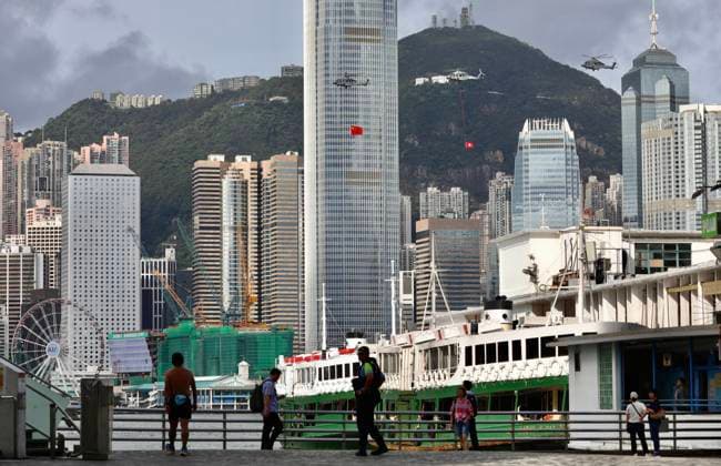 July 1, 2026, Hong Kong, China: In Hong Kong this morning, annual ceremonial helicopter fly over displaying national flag of PRC and official flag of HKSAR flying past IFC Tower, one of the tallest building in Hong Kong. Today marks 29th anniversary of former British Colony s HANDOVER to Chinese Communist Regime.July-1,2026Hong Kong.ZUMA Hong Kong China - ZUMAl137 20260701_fap_l137_005 Copyright: xLiauxChung-renx