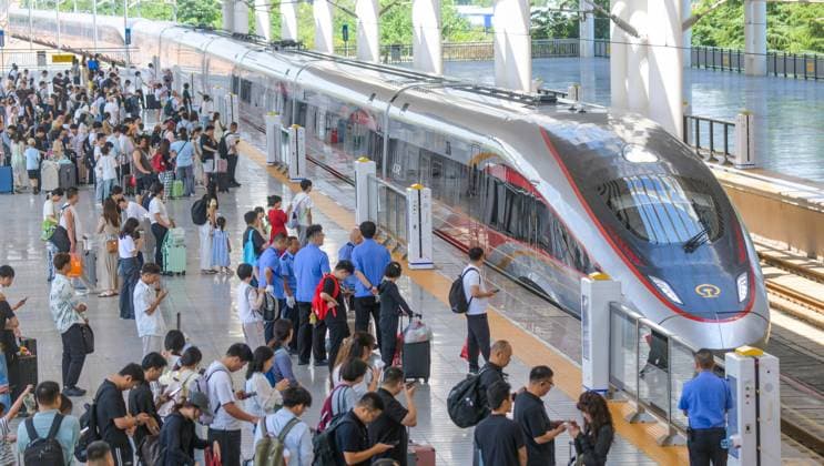 LUOYANG, CHINA - JULY 01: Passengers board a Fuxing bullet train at Luoyang Longmen Railway Station on July 1, 2026 in Luoyang, Henan Province of China. China Railway has adjusted the train operation diagram to kick off the summer transportation season.  Copyright: xVCGx 111651582413