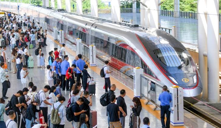 LUOYANG, CHINA - JULY 01: Passengers board a Fuxing bullet train at Luoyang Longmen Station on July 1, 2026 in Luoyang, Henan Province of China. China Railway has adjusted the train operation map to mark the start of the summer transport season.  Copyright: xVCGx 111651582414