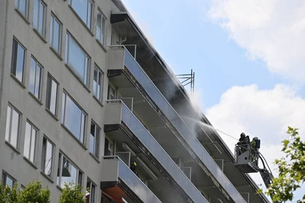 Firefighters pictured at the scene of a fire in an apartment building in the August Vermeylenlaan street in Antwerp on Wednesday 01 July 2026. According to the first information the fire broke out on the eighth level of the 10-floor building.  JONASxROOSENS 180075679