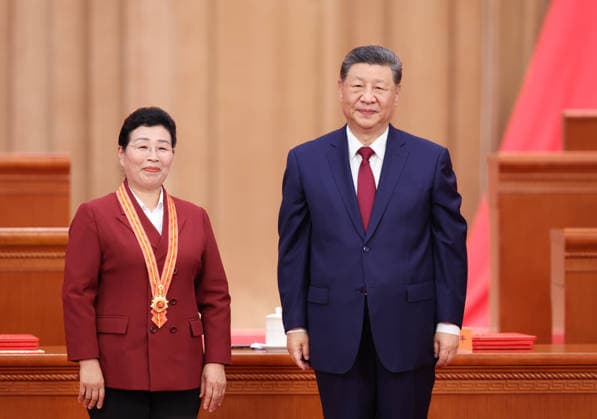 (260701) -- BEIJING, July 1, 2026 -- Chinese President Xi Jinping, also general secretary of the Communist Party of China (CPC) Central Committee and chairman of the Central Military Commission, confers the July 1 Medal, the Party s highest honor, on Wu Yaqin in Beijing, capital of China, July 1, 2026. A gathering marking the CPC s 105th founding anniversary was held at the Great Hall of the People in Beijing on Wednesday. ) CHINA-BEIJING-CPC-105TH FOUNDING ANNIVERSARY-GATHERING (CN) YaoxDawei 