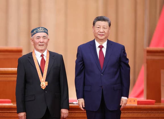 (260701) -- BEIJING, July 1, 2026 -- Chinese President Xi Jinping, also general secretary of the Communist Party of China (CPC) Central Committee and chairman of the Central Military Commission, confers the July 1 Medal, the Party s highest honor, on Uhas Sulayman in Beijing, capital of China, July 1, 2026. A gathering marking the CPC s 105th founding anniversary was held at the Great Hall of the People in Beijing on Wednesday. ) CHINA-BEIJING-CPC-105TH FOUNDING ANNIVERSARY-GATHERING (CN) YaoxDawei 