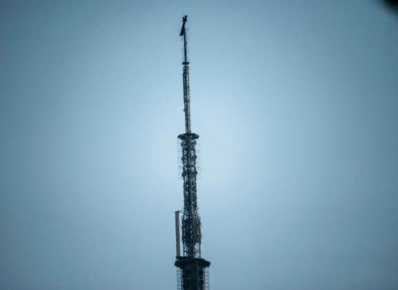 Trespassers on the Empire State Building Two people climbed to the top of the Empire State Building in New York on Wednesday, July 1, 2026 and unfurled a black banner saying When the power of love beats the love of power, the world knows peace, (  RichardxB.xLevine