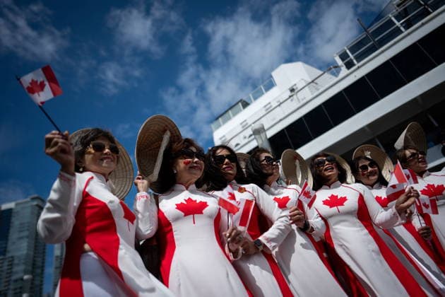 July 1, 2026, Vancouver, Bc, CANADA: A group of Vietnamese women dressed in Canada dresses pose for a photo during Canada Day Celebrations in Vancouver, on Wednesday, July 1, 2026. Vancouver CANADA  - ZUMAc35_ 20260701_zaf_c35_075 Copyright: xEthanxCairnsx
