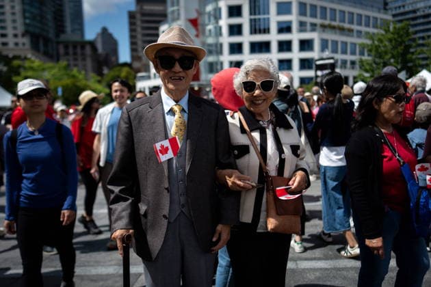 July 1, 2026, Vancouver, Bc, CANADA: Poo, left, and Min Li walk during Canada Day Celebrations in Vancouver, on Wednesday, July 1, 2026. Vancouver CANADA  - ZUMAc35_ 20260701_zaf_c35_076 Copyright: xEthanxCairnsx