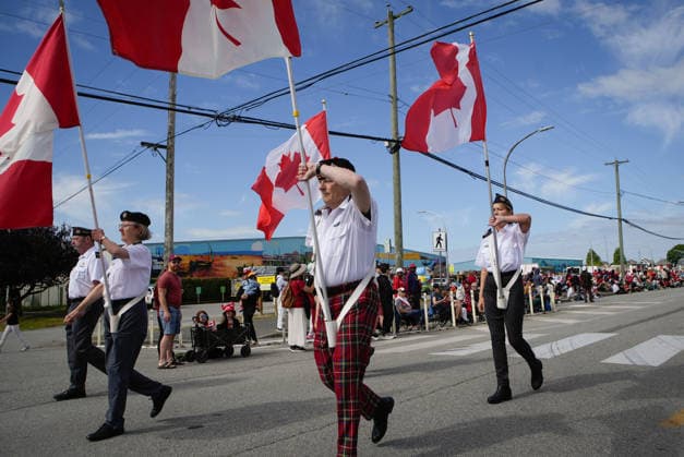 (260702) -- RICHMOND, July 2, 2026 -- Participants carrying Canadian flags take part in the Canada Day Parade in Richmond, British Columbia, Canada, on July 1, 2026. (Photo by Xinhua) CANADA-RICHMOND-CANADA DAY-PARADE LiangxSen 