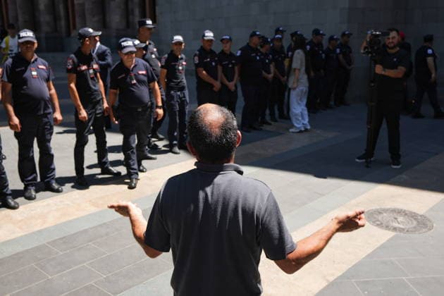 ARMENIA, YEREVAN - JULY 2, 2026: A man looks at police officers during a protest outside the Government House amid talks between European Commission President von der Leyen and Armenia s President Pashinyan. Alexander Patrin TASS  94569543