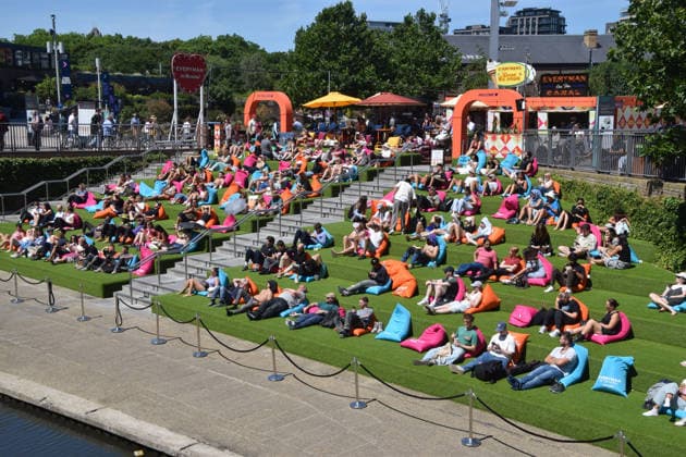July 2, 2026, London, England, United Kingdom: People watch Wimbledon tennis matches on the large Everyman On The Canal screen in Granary Square next to Regent s Canal in King s Cross. The cinema chain sets up the screen, beanbags, a bar, and free sport and film screenings during the summer months. London United Kingdom - ZUMAv130 20260702_zip_v130_025 Copyright: xVukxValcicx
