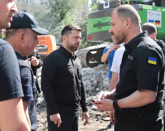 Chief of the State Emergency Service of Ukraine Andrii Danyk, President of Ukraine Volodymyr Zelenskyy and Minister of Internal Affairs of Ukraine Ihor Klymenko (L to R) visit a severely damaged apartment block in the Darnytskyi district during an ongoing search-and-rescue operation after a massive Russian missile attack, Kyiv, Ukraine, July 2, 2026. President Zelenskyy stated that Ukraine does not currently have a sufficient number of PAC-3 missiles for its Patriot air defence systems to repel large-scale Russian attacks involving more than 70 ballistic missiles. As reported, the death toll from Russia’s latest combined missile and drone assault on Kyiv has risen to 22, with emergency response operations ongoing at seven locations across t  Copyright: xHennadiixMinchenkox