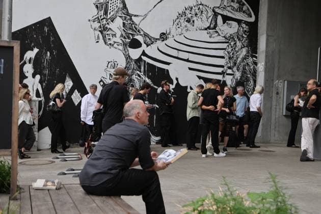 Germany: Platte Presents Taskin Goec collections Berlin, Germany - July 2, 2026. Designer Taskin Goec is presenting her collection at the Lobe Block—a striking concrete building in Berlin’s Gesundbrunnen district—exploring the tension between classic design and artificial intelligence. The photo shows visitors in front of the fashion show. Berlin Berlin Germany Copyright: SimonexKuhlmey