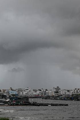 (260703) -- QIONGHAI, July 3, 2026 -- This photo taken on July 3, 2026 shows dark clouds at Tanmen central fishing port in Qionghai, south China s Hainan Province. Typhoon Maysak, the 10th typhoon of the year, made landfall on the coast of south China s Hainan Province on Friday evening, suspending train, ferry and flight services and closing schools in some areas. The tropical storm came ashore at around 6:20 p.m. in Yelin Township of Lingshui Li Autonomous County, according to the Hainan provincial meteorological bureau. At landfall, it packed maximum winds of 23 meters per second near its center. The typhoon is forecast to move northwest, passing through Baoting, Wuzhishan, Baisha and Danzhou before entering the Beibu Gulf, the me 