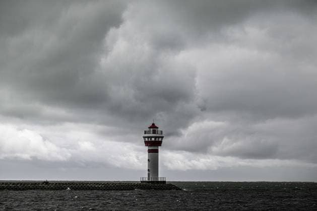 (260703) -- QIONGHAI, July 3, 2026 -- This photo taken on July 3, 2026 shows dark clouds at Tanmen central fishing port in Qionghai, south China s Hainan Province. Typhoon Maysak, the 10th typhoon of the year, made landfall on the coast of south China s Hainan Province on Friday evening, suspending train, ferry and flight services and closing schools in some areas. The tropical storm came ashore at around 6:20 p.m. in Yelin Township of Lingshui Li Autonomous County, according to the Hainan provincial meteorological bureau. At landfall, it packed maximum winds of 23 meters per second near its center. The typhoon is forecast to move northwest, passing through Baoting, Wuzhishan, Baisha and Danzhou before entering the Beibu Gulf, the me 