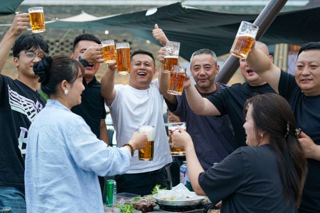 HARBIN, CHINA - JULY 03: Citizens drink beer at a beer garden during the opening of the 24th Harbin International Beer Festival on July 3, 2026 in Harbin, Heilongjiang Province of China. The festival features eight functional zones including five beer tents and 11 international beer gardens.  Copyright: xChinaxNewsxServicex 111652053296