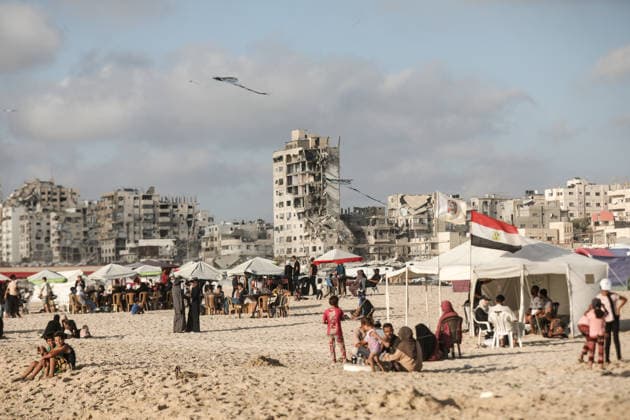 Gazan families gather along the Mediterranean amid rising summer temperatures GAZA, PALESTINE - JULY 3: Hundreds of displaced Palestinian families gather along the Mediterranean coastline in the Gaza Strip on July 3, 2026, seeking a respite from intense heatwaves and ongoing Israeli military operations. As temperatures soared across the enclave, thousands of residents fled the suffocating camps to swim and rest on the sandy beaches. Moiz Salhi Anadolu Gaza City Gaza. Editorial use only. Please get in touch for any other usage.  Copyright: x2026xAnadoluxMoizxSalhix