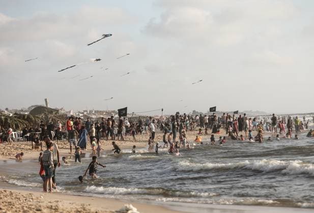 Gazan families gather along the Mediterranean amid rising summer temperatures GAZA, PALESTINE - JULY 3: Hundreds of displaced Palestinian families gather along the Mediterranean coastline in the Gaza Strip on July 3, 2026, seeking a respite from intense heatwaves and ongoing Israeli military operations. As temperatures soared across the enclave, thousands of residents fled the suffocating camps to swim and rest on the sandy beaches. Moiz Salhi Anadolu Gaza City Gaza. Editorial use only. Please get in touch for any other usage.  Copyright: x2026xAnadoluxMoizxSalhix