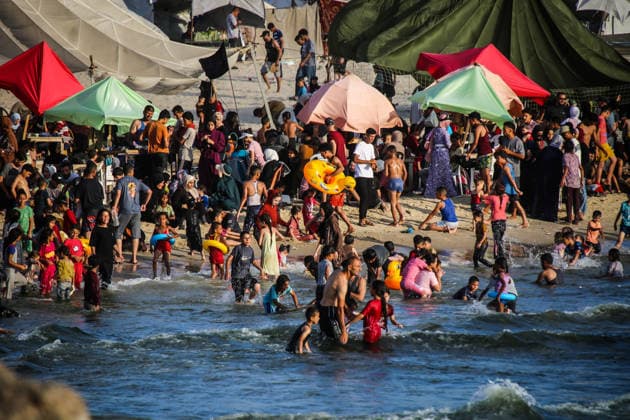 Palestinians flock to the coastline seeking relief from the heat GAZA CITY, GAZA, PALESTINE - JULY 03: As Israel s attacks on the Gaza Strip continues and soaring temperatures intensifies already harsh living conditions, Palestinians flock to the coastline seeking relief in Gaza City, Gaza, Palestine on July 03, 2026. Escaping the sweltering heat inside their tents, many sought relief by swimming off the coast of Gaza City, hoping to cool off and briefly escape the hardships of war. Saeed M. M. T. Jaras Anadolu Gaza City Gaza. Editorial use only. Please get in touch for any other usage.  Copyright: x2026xAnadoluxSaeedxM.xM.xT.xJarasx