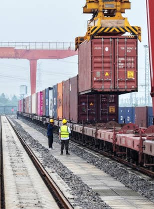 YANGZHOU, CHINA - JULY 04: A freight train loads containers at the Jiangdu railway dedicated line logistics base on July 4, 2026 in Yangzhou, Jiangsu Province of China. China s state railway completed a freight volume of over 2 billion tons in the first half of 2026.  Copyright: xVCGx 111652158878