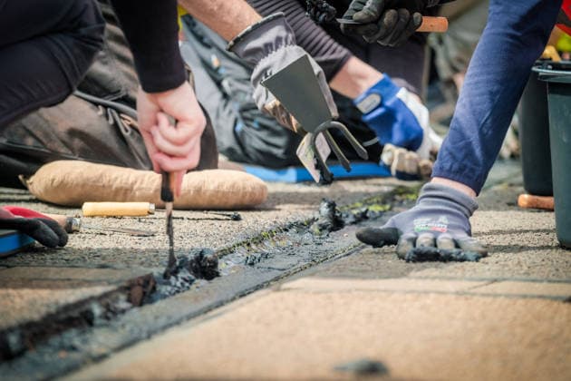 Freiwillige Helfer reinigen gemeinsam mit Mitarbeitenden der Leipziger Verkehrsbetriebe (LVB) Straßenbahngleise an der Leibnizstraße in Leipzig (Sachsen) von geschmolzenem Bitumen. Die Arbeiten sind Teil eines dritten Subbotniks zur Beseitigung der Hitzeschäden am Straßenbahnnetz. Aufnahme vom 4. Juli 2026. Hilfsaktion Leipzig *** Volunteers are working alongside employees of the Leipzig Public Transportation Authority (LVB) to clean melted bitumen from the tram tracks on Leibnizstraße in Leipzig, Saxony. The work is part of a third subbotnik aimed at repairing heat damage to the tram network. Photo taken on July 4, 2026. VolunteerLeipzig Relief Effort