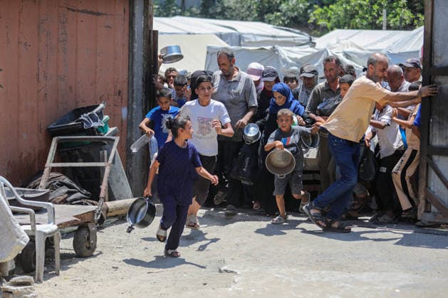 Hot meals distributed to Palestinians in Gaza under Israeli attacks NUSEIRAT, GAZA, PALESTINE - JULY 4: Palestinians, including children, rush toward a food distribution point carrying empty pots and containers in the Nuseirat refugee camp in central Gaza on July 4, 2026. Food shortages continue across the Gaza Strip as Israeli blockade and restrictions on the entry of humanitarian aid persist. Hassan Jedi Anadolu Nuseirat Gaza. Editorial use only. Please get in touch for any other usage.  Copyright: x2026xAnadoluxHassanxJedix