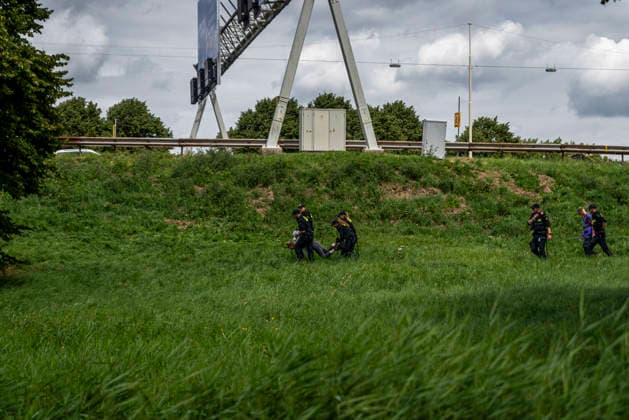 July 4, 2026, Utrecht, Utrecht, Netherlands: 4 July 2026, Utrecht, the Netherlands. Dutch police carry a climate activist being arrested for attempting to block a major Dutch highway. Climate activists from Extinction Rebellion and Utrecht for Palestine blocked the A12 highway near Utrecht, Netherlands, demanding an end to billions in annual fossil fuel subsidies. Utrecht Netherlands  - ZUMAp202 20260704_zip_p202_017 Copyright: xJamesxPetermeierx