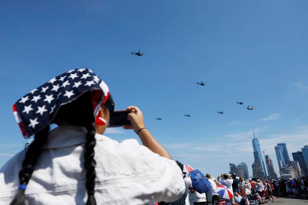 Spectators watch a helicopter flyover as part of Sail4th 250, a celebration for America s 250th anniversary, in New York City on Saturday, July 4, 2026. The event includes over 100 tall ships and navy vessels from more than 30 nations.  NYP20260704213 JOHNxANGELILLO