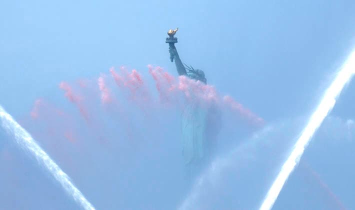New York City Fire Department boats spray red, white and blue water in the air near he Statue of Liberty as part of Sail4th 250, a celebration for America s 250th anniversary, in New York City on Saturday, July 4, 2026. The event includes over 100 tall ships and navy vessels from more than 30 nations.  NYP20260704230 JOHNxANGELILLO