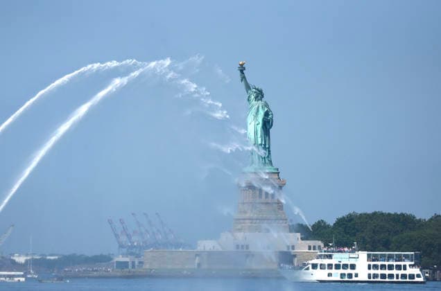 New York City Fire Department boats spray water in the air near he Statue of Liberty as part of Sail4th 250, a celebration for America s 250th anniversary, in New York City on Saturday, July 4, 2026. The event includes over 100 tall ships and navy vessels from more than 30 nations.  NYP20260704234 JOHNxANGELILLO