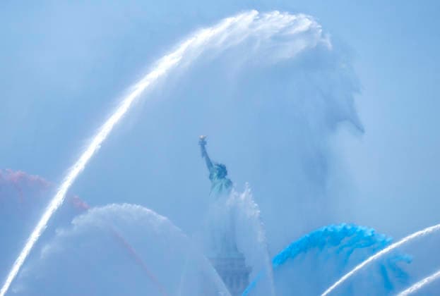 New York City Fire Department boats spray red, white and blue water in the air near the Statue of Liberty as part of Sail4th 250, a celebration for America s 250th anniversary, in New York City on Saturday, July 4, 2026. The event includes over 100 tall ships and navy vessels from more than 30 nations.  NYP20260704232 JOHNxANGELILLO