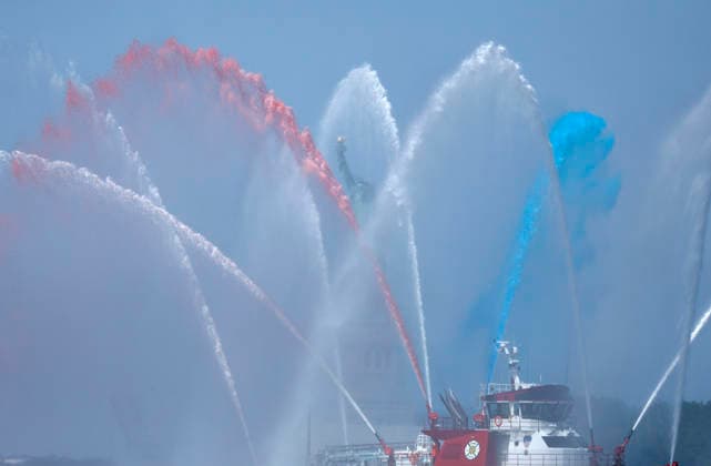 New York City Fire Department boats spray red, white and blue water in the air near the Statue of Liberty as part of Sail4th 250, a celebration for America s 250th anniversary, in New York City on Saturday, July 4, 2026. The event includes over 100 tall ships and navy vessels from more than 30 nations.  NYP20260704227 JOHNxANGELILLO