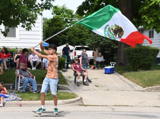 News Bilder des Tages July 4, 2026, Racine, Wisconsin, USA: A youngster waves a large Mexican flag as he skateboards along the parade route as Racine, Wisconsin hosts its 90th annual 4th of July parade on Main Street July 4, 2026.The theme was Ã¢â‚¬oeHappy 250 America. Racine USA  - ZUMAh154 20260704_znp_h154_013 Copyright: xMarkxHertzbergx
