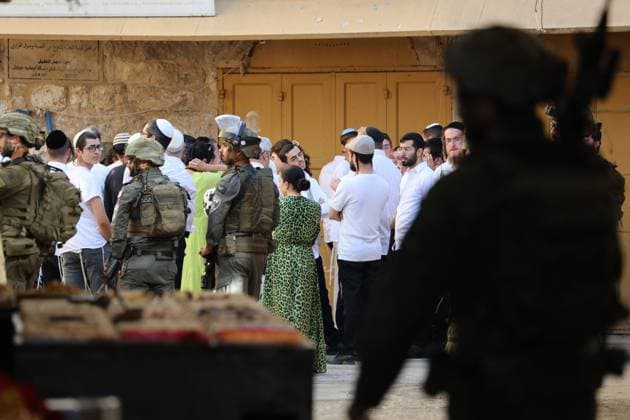 HEBRON, WEST BANK JULY 4, 2026: Israeli settlers enter the Old City of Hebron under the protection of Israeli security forces during a weekly organized visit. The visits, which take place under military escort, are opposed by many Palestinian residents and are a recurring source of tension in the city. HEBRON Palestine, State of Copyright: x xMosabxshawerx xJNAxPressx