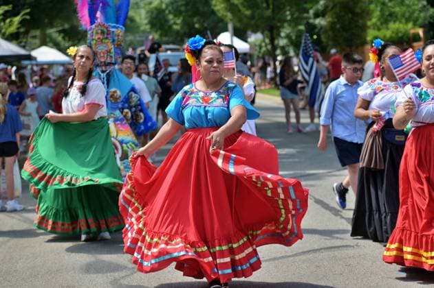 4th of July Parade in Des Plaines, Illinois DES PLAINES, ILLINOIS - JULY 4: Dancers in vibrant, embroidered blouses and flowing skirts perform along the parade route during the 2026 Des Plaines 4th of July Parade. In the image 4th of July 2026 Des Plaines Illinois USA (14).jpg, a woman in a red skirt and blue top leads a group of participants, while others in the background carry American flags and wear traditional attire during the city s Independence Day festivities. Jacek Boczarski Anadolu Illinois United States. Editorial use only. Please get in touch for any other usage.  Copyright: x2026xAnadoluxJacekxBoczarskix