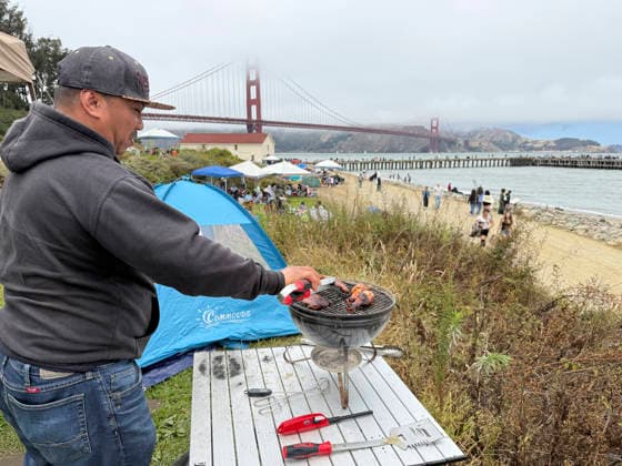 A Fourth of July spectator grills a meal after showing up 24 hours early to get a good spot to watch the fireworks display on the Golden Gate Bridge for the 250th anniversary of the United States in Sausalito, California on Saturday, July 4, 2026.  SXP2026070401 TERRYxSCHMITT