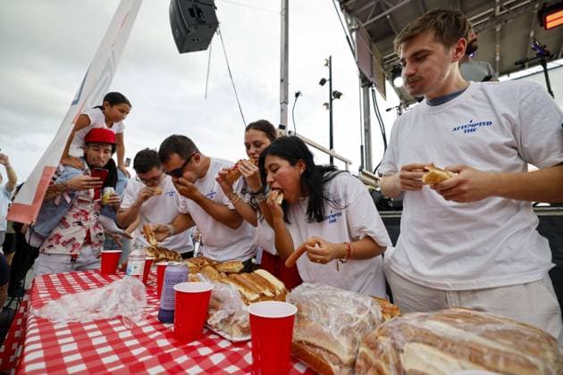 July 4, 2026, Tampa, Florida, USA: Contestants compete to a crowd of hundreds at the Where my Dogs at? Hot Dog Eating Contest at Armature Works part of the Liberty By The Bay citywide celebration on Saturday, July 4, 2026 in Tampa. Tampa USA  - ZUMAs70_ 20260704_zan_s70_005 Copyright: xLuisxSantanax