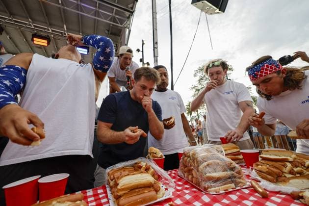 July 4, 2026, Tampa, Florida, USA: Contestants compete to a crowd of hundreds at the Where my Dogs at? Hot Dog Eating Contest at Armature Works part of the Liberty By The Bay citywide celebration on Saturday, July 4, 2026 in Tampa. Tampa USA - ZUMAs70_ 20260704_zan_s70_007 Copyright: xLuisxSantanax
