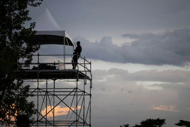 US Secret Service officer stands on a watch tower as attendees evacuate due to thunderstorms in the area during the Salute to America Independence Day celebration on the National Mall as watch the flyover on the National Mall in Washington, DC, on July 4, 2026. The nation is marking the 250th anniversary of the United States Declaration of Independence.  WAP20260704208 DANIELxHEUER