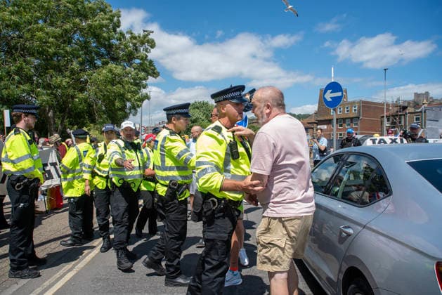 July 4, 2026, Dover, United Kingdom: A police officer holds back a far-right protester during a demonstration in Dover. Around 100-120 supporters of the Pink Ladies gathered from across the country in Dover, UK. The Pink Ladies is an anti immigration far-right movement. The far-right activists marched through central Dover to the Immigration Centre and they were confronted by a small group of antifascist counter-protesters during their march. Dover United Kingdom  - ZUMAs197 20260704_aaa_s197_211 Copyright: xKrisztianxElekx