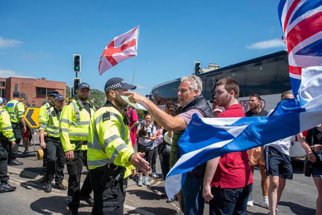 July 4, 2026, Dover, United Kingdom: A far-right protester shouts at the antifascists during a demonstration in Dover. Around 100-120 supporters of the Pink Ladies gathered from across the country in Dover, UK. The Pink Ladies is an anti immigration far-right movement. The far-right activists marched through central Dover to the Immigration Centre and they were confronted by a small group of antifascist counter-protesters during their march. Dover United Kingdom  - ZUMAs197 20260704_aaa_s197_213 Copyright: xKrisztianxElekx