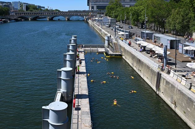 (260705) -- PARIS, July 5, 2026 -- People swim in the Seine River, Paris, France, on July 4, 2026. Paris opened some swimming sites in the Seine River to help people escape heat on Saturday. (Photo by Xinhua) FRANCE-PARIS-SEINE RIVER-SWIMMING-OPEN EmmaxDaxSilva 