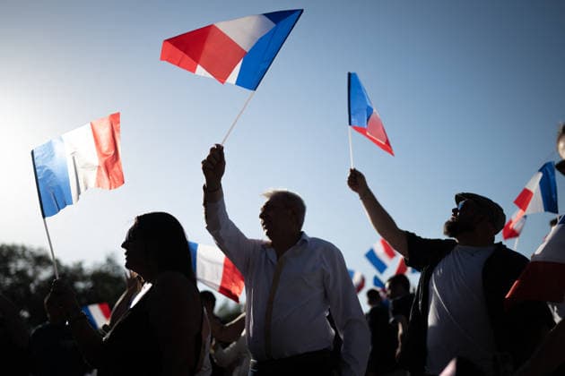 Marine Le Pen and Jordan Bardella at the RN party event La fete champetre - Lievin AJ This photo is an illustration of a participant holds French flags during a RN party event La fete champetre in Lievin, northern France on July 4, 2026. Photo by Alexis Jumeau ABACAPRESS.COM. Paris France  Copyright: xJumeauxAlexis ABACAx