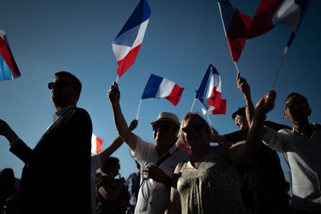 Marine Le Pen and Jordan Bardella at the RN party event La fete champetre - Lievin AJ This photo is an illustration of a participant holds French flags during a RN party event La fete champetre in Lievin, northern France on July 4, 2026. Photo by Alexis Jumeau ABACAPRESS.COM. Paris France  Copyright: xJumeauxAlexis ABACAx