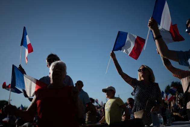 Marine Le Pen and Jordan Bardella at the RN party event La fete champetre - Lievin AJ This photo is an illustration of a participant holds French flags during a RN party event La fete champetre in Lievin, northern France on July 4, 2026. Photo by Alexis Jumeau ABACAPRESS.COM. Paris France  Copyright: xJumeauxAlexis ABACAx