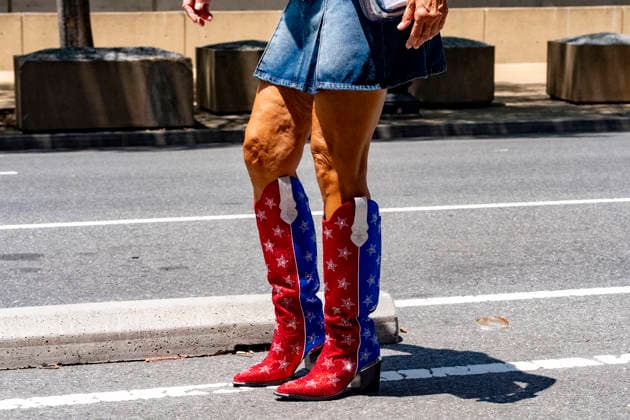 July 4, 2026, Washington, United States: A woman poses with U.S. flag boots outside the Great American State Fair on the National Mall, in Washington. Washington United States  - ZUMAs197 20260704_aaa_s197_236 Copyright: xJenxGolbeckx