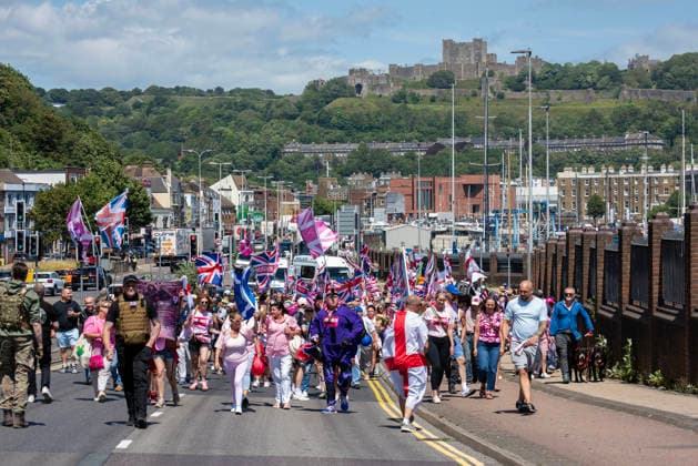 July 4, 2026, Dover, United Kingdom: Far-right protesters march with flags during a demonstration in Dover. Around 100-120 supporters of the Pink Ladies gathered from across the country in Dover, UK. The Pink Ladies is an anti immigration far-right movement. The far-right activists marched through central Dover to the Immigration Centre and they were confronted by a small group of antifascist counter-protesters during their march. Dover United Kingdom - ZUMAs197 20260704_aaa_s197_208 Copyright: xKrisztianxElekx