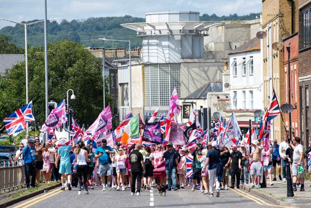 July 4, 2026, Dover, United Kingdom: Far-right protesters march with flags during a demonstration in Dover. Around 100-120 supporters of the Pink Ladies gathered from across the country in Dover, UK. The Pink Ladies is an anti immigration far-right movement. The far-right activists marched through central Dover to the Immigration Centre and they were confronted by a small group of antifascist counter-protesters during their march. Dover United Kingdom - ZUMAs197 20260704_aaa_s197_209 Copyright: xKrisztianxElekx